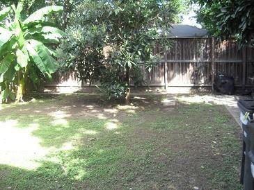 1806 West Main Street, Unit 8 Houston, TX 77098 - Photo 7 of 7 a view of a yard with large trees and wooden fence