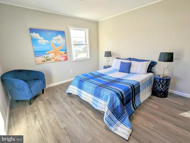 a bedroom with a bed a couch and a window