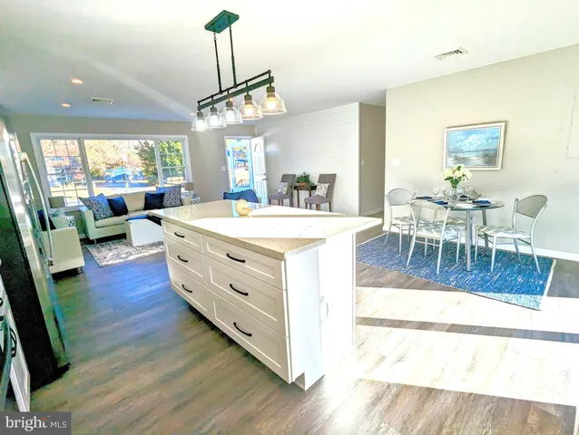 a view of a dining room with furniture wooden floor and chandelier