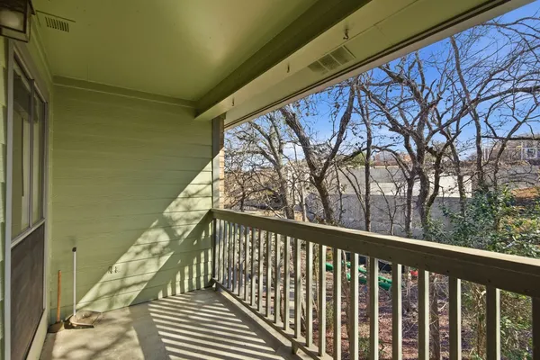 a view of a balcony with wooden fence