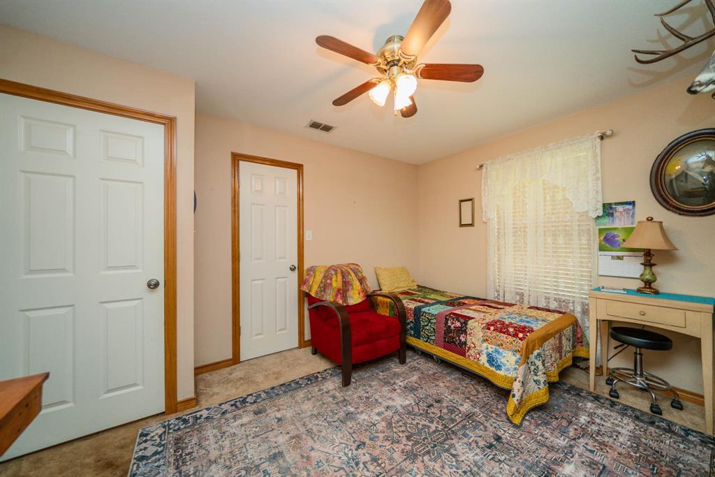 14266 Timberidge Lane Winona, TX 75792 - Photo 17 of 33 a bedroom with a bed and a chandelier