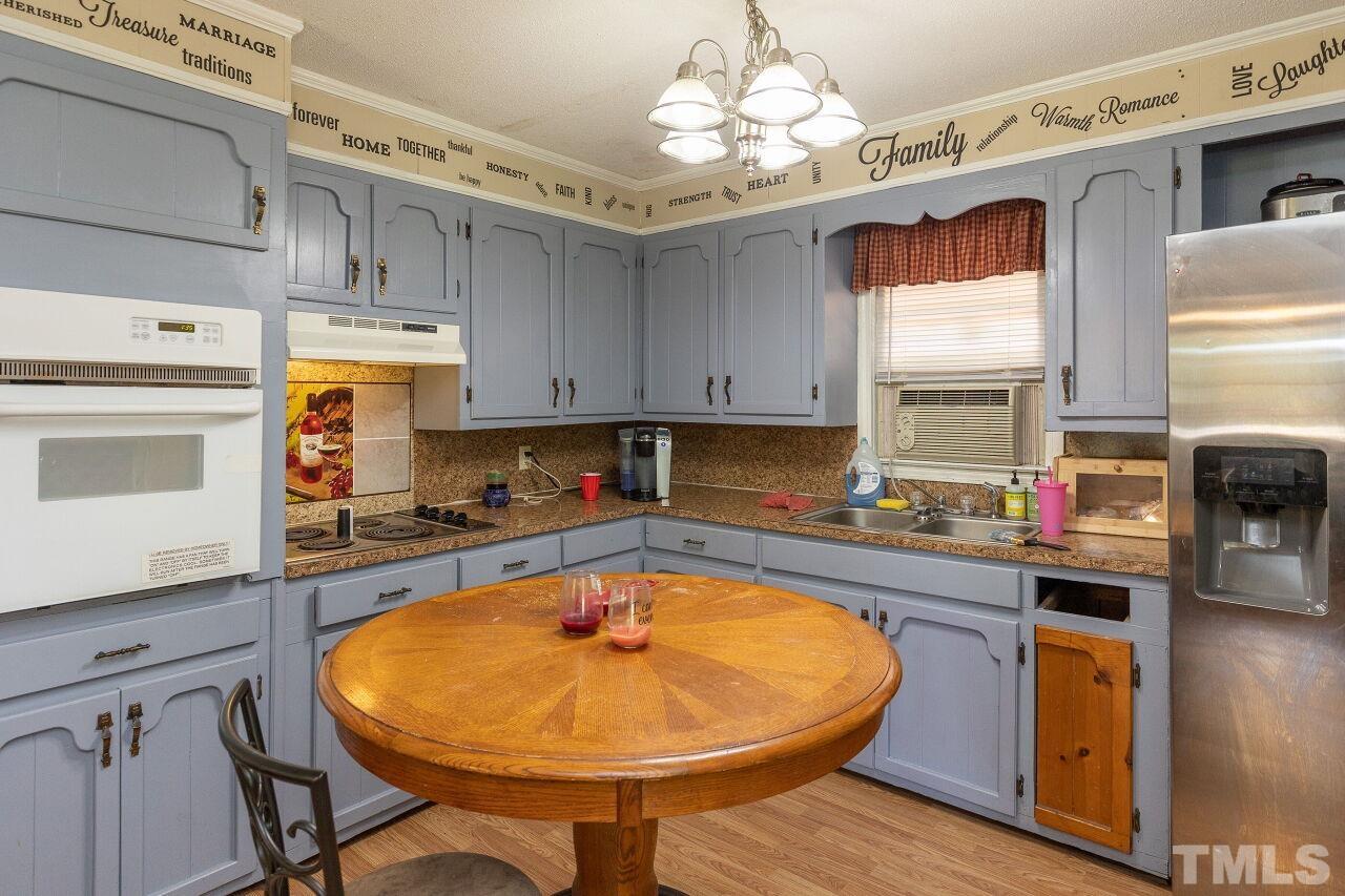 680 Haywood Bailey Road Roxboro, NC 27574 - Photo 11 of 29 a kitchen with stainless steel appliances granite countertop a sink a stove and cabinets