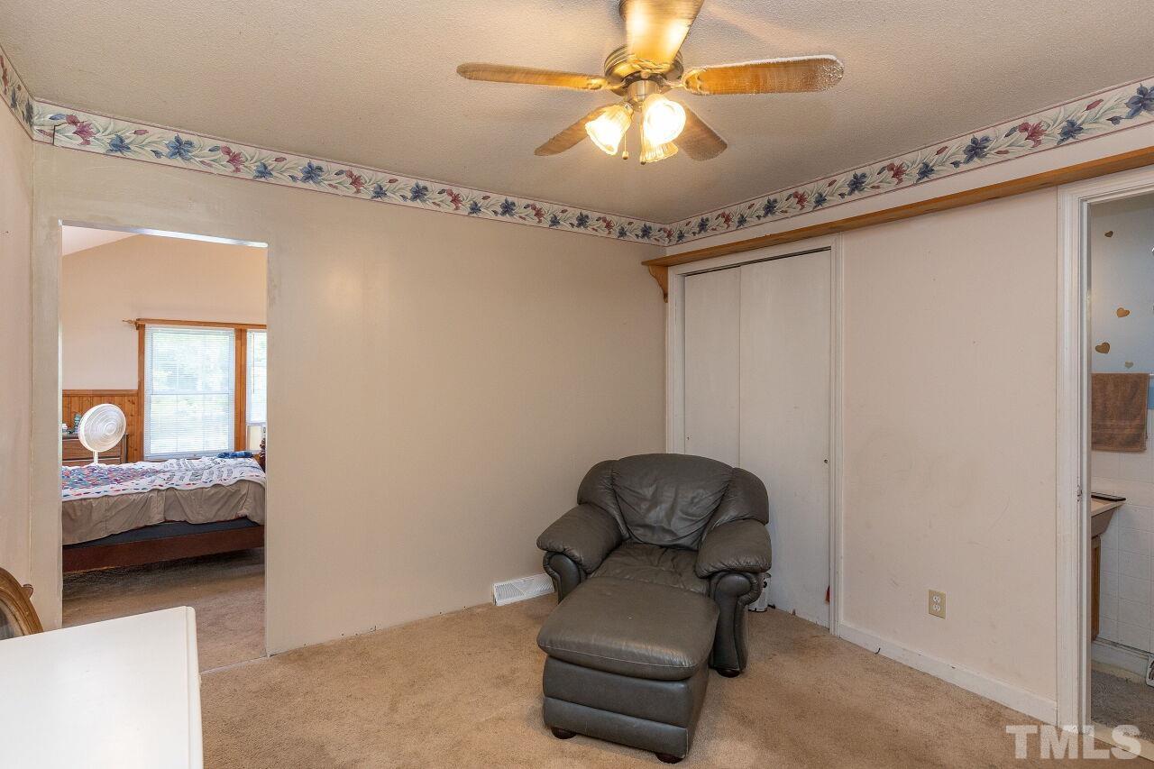 680 Haywood Bailey Road Roxboro, NC 27574 - Photo 12 of 29 a living room with furniture and a chandelier