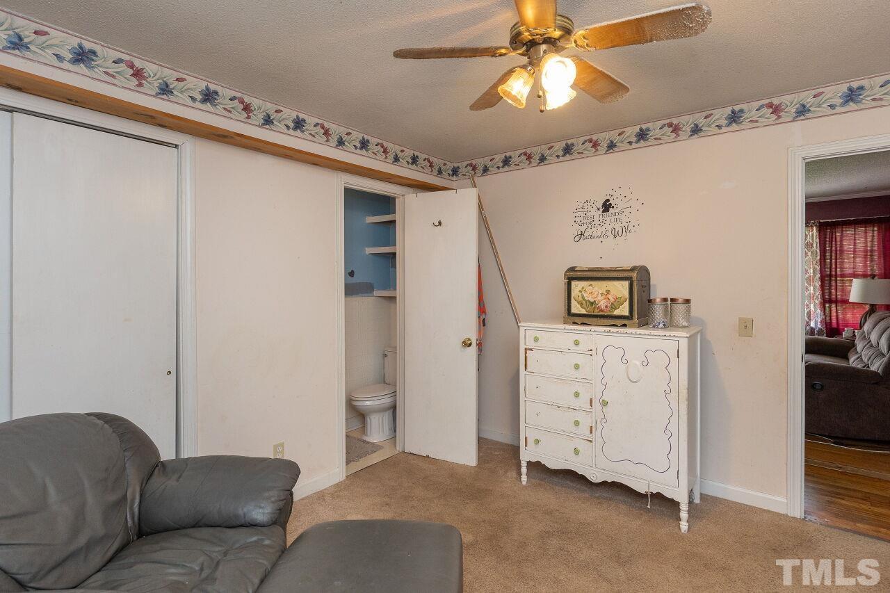 680 Haywood Bailey Road Roxboro, NC 27574 - Photo 13 of 29 a living room with furniture and a ceiling fan
