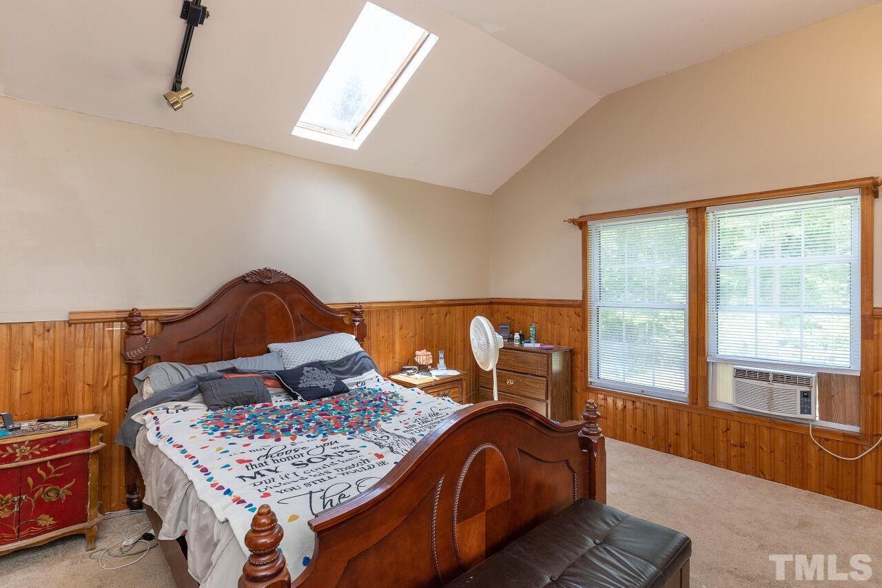 680 Haywood Bailey Road Roxboro, NC 27574 - Photo 15 of 29 a bed sitting in a bedroom next to a window