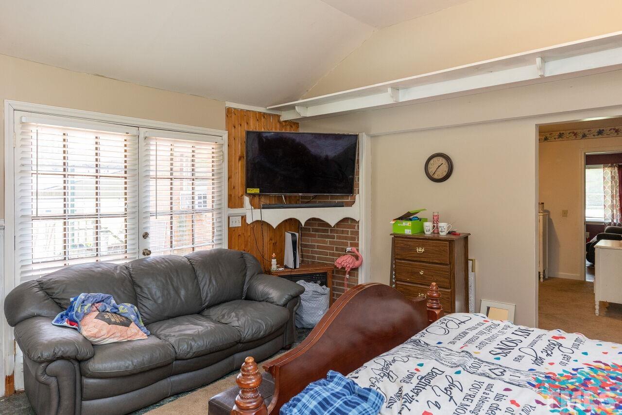 680 Haywood Bailey Road Roxboro, NC 27574 - Photo 17 of 29 a living room with furniture and a flat screen tv