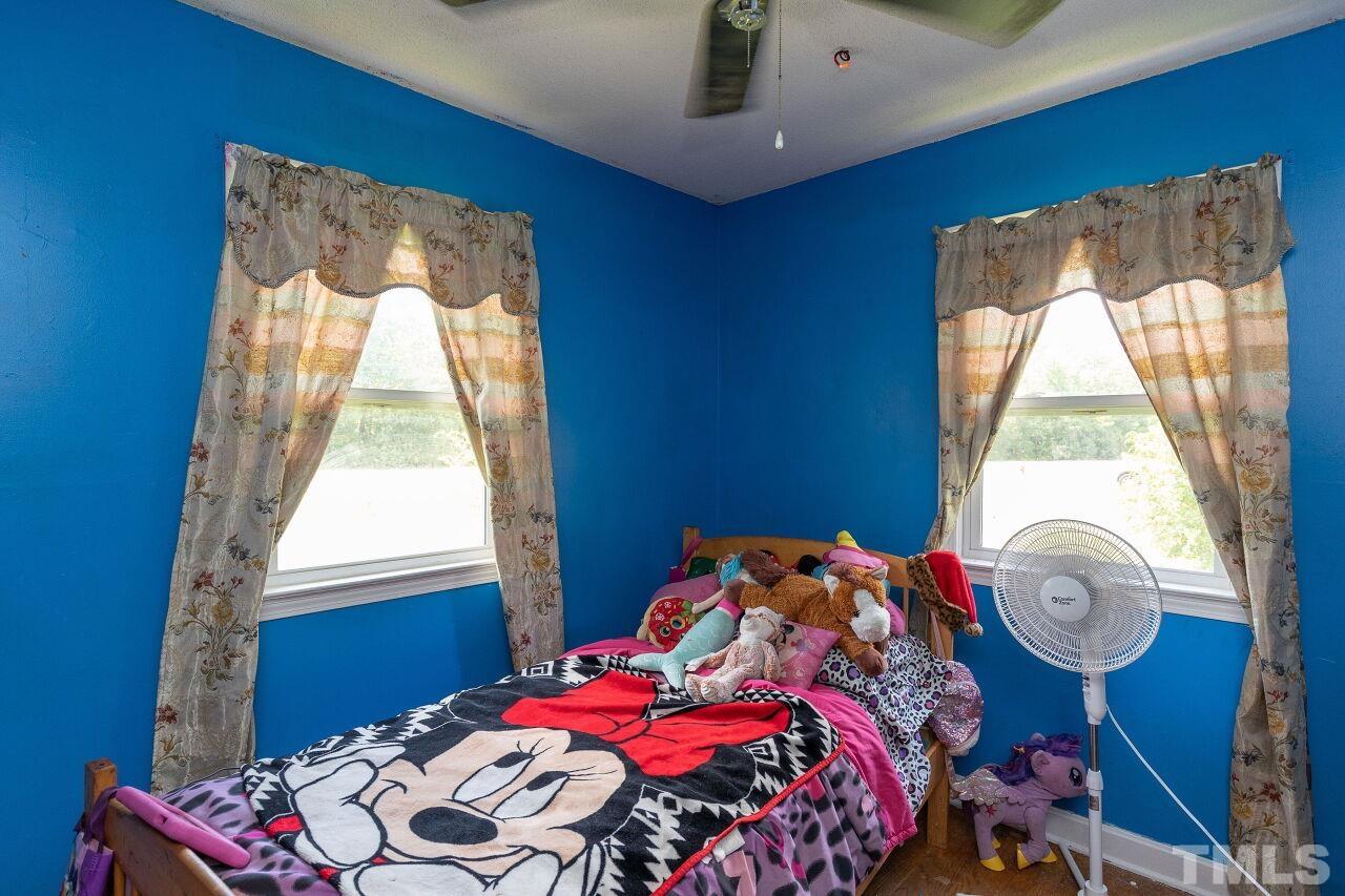 680 Haywood Bailey Road Roxboro, NC 27574 - Photo 18 of 29 a bedroom with a bed and a window