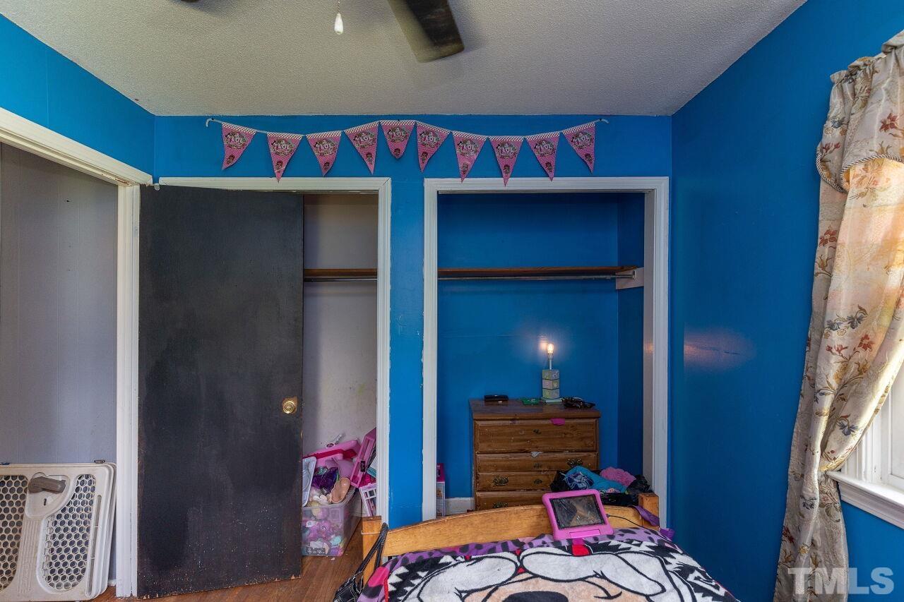 680 Haywood Bailey Road Roxboro, NC 27574 - Photo 19 of 29 a bedroom with a bed and a closet