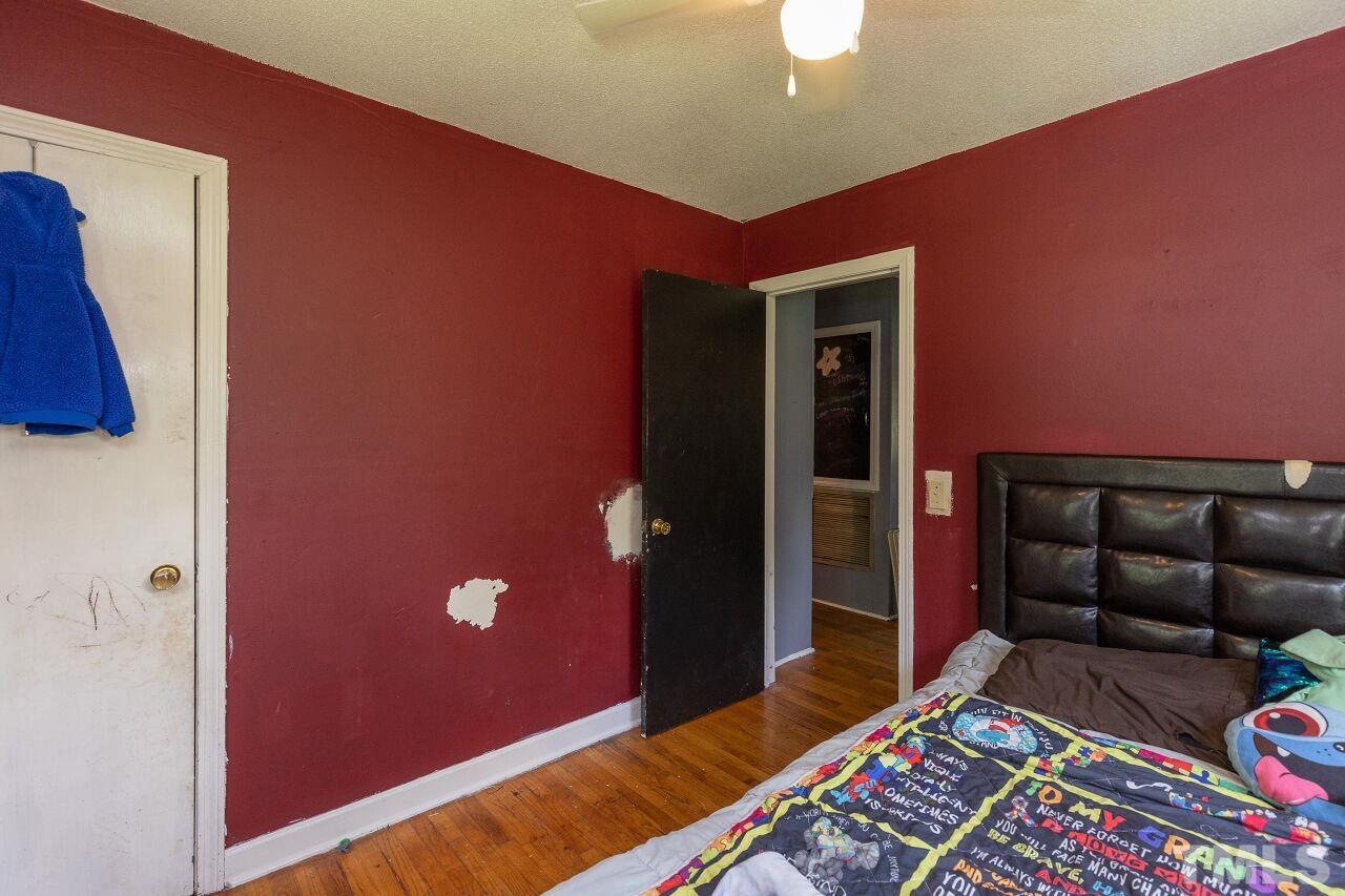 680 Haywood Bailey Road Roxboro, NC 27574 - Photo 21 of 29 a bedroom with a bed and a lamp on dresser