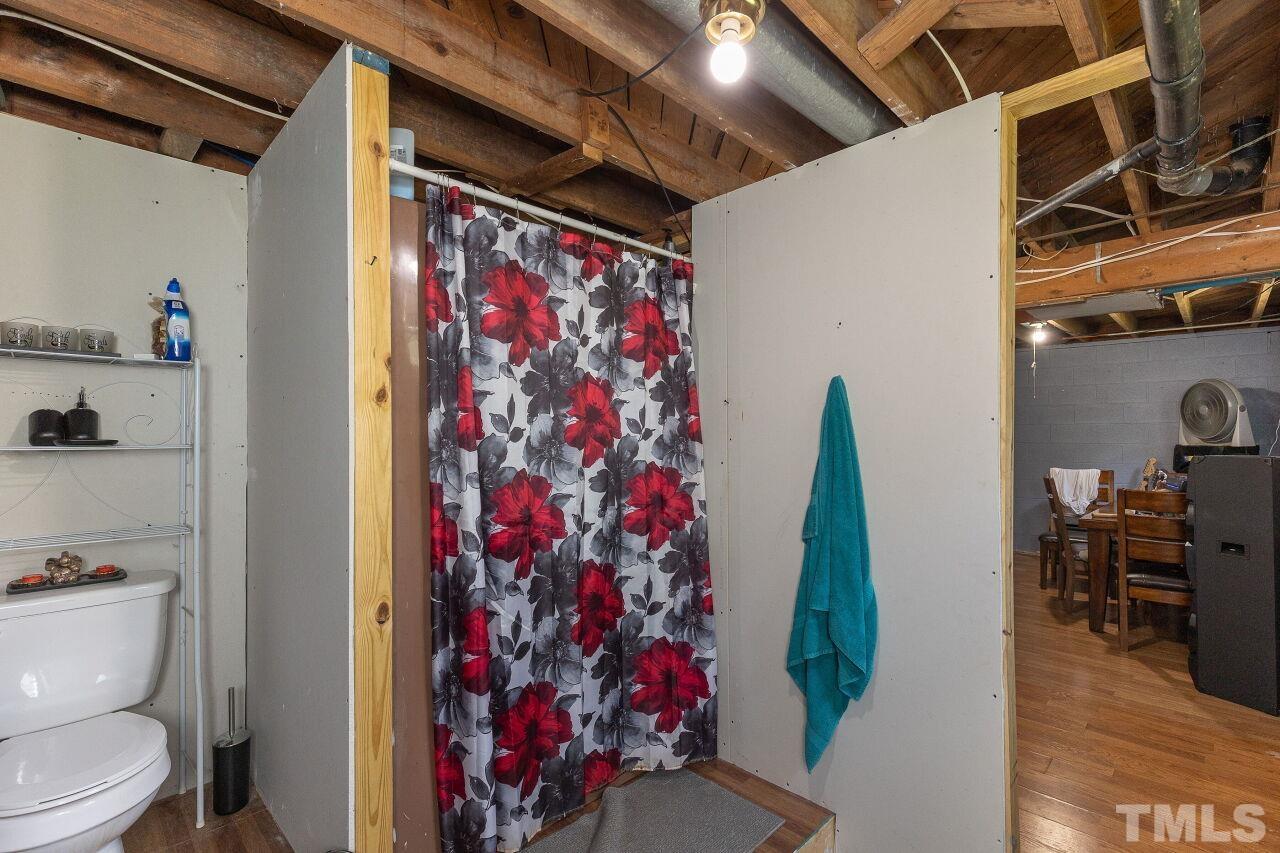 680 Haywood Bailey Road Roxboro, NC 27574 - Photo 26 of 29 a view of a hallway with wooden floor and dining room