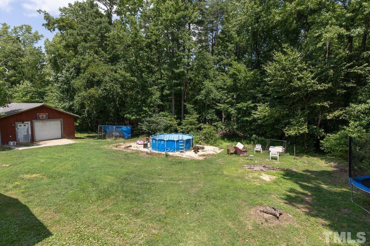 680 Haywood Bailey Road Roxboro, NC 27574 - Photo 28 of 29 a view of a backyard with large trees