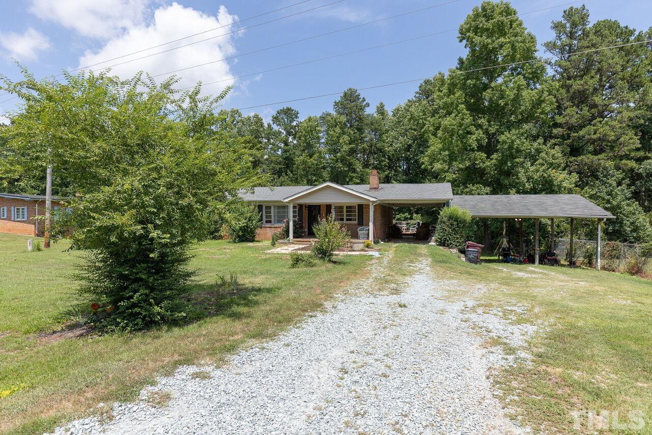 680 Haywood Bailey Road Roxboro, NC 27574 - Photo 3 of 29 a front view of a house with garden