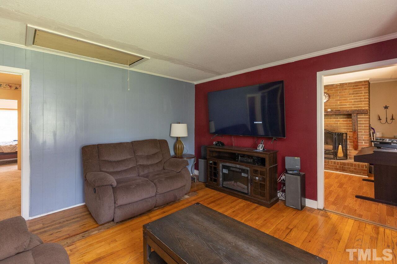 680 Haywood Bailey Road Roxboro, NC 27574 - Photo 6 of 29 a living room with furniture and a flat screen tv