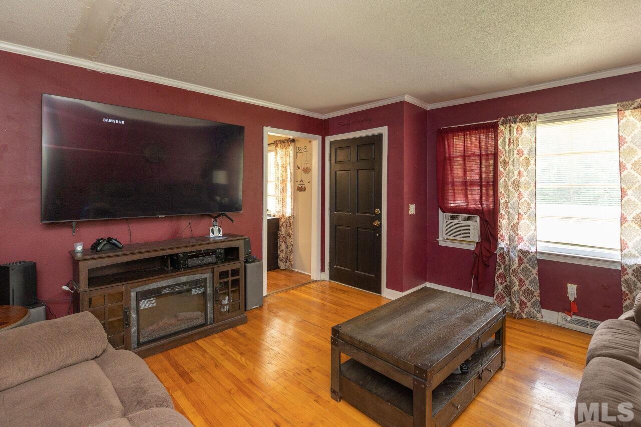 680 Haywood Bailey Road Roxboro, NC 27574 - Photo 7 of 29 a living room with furniture and a flat screen tv
