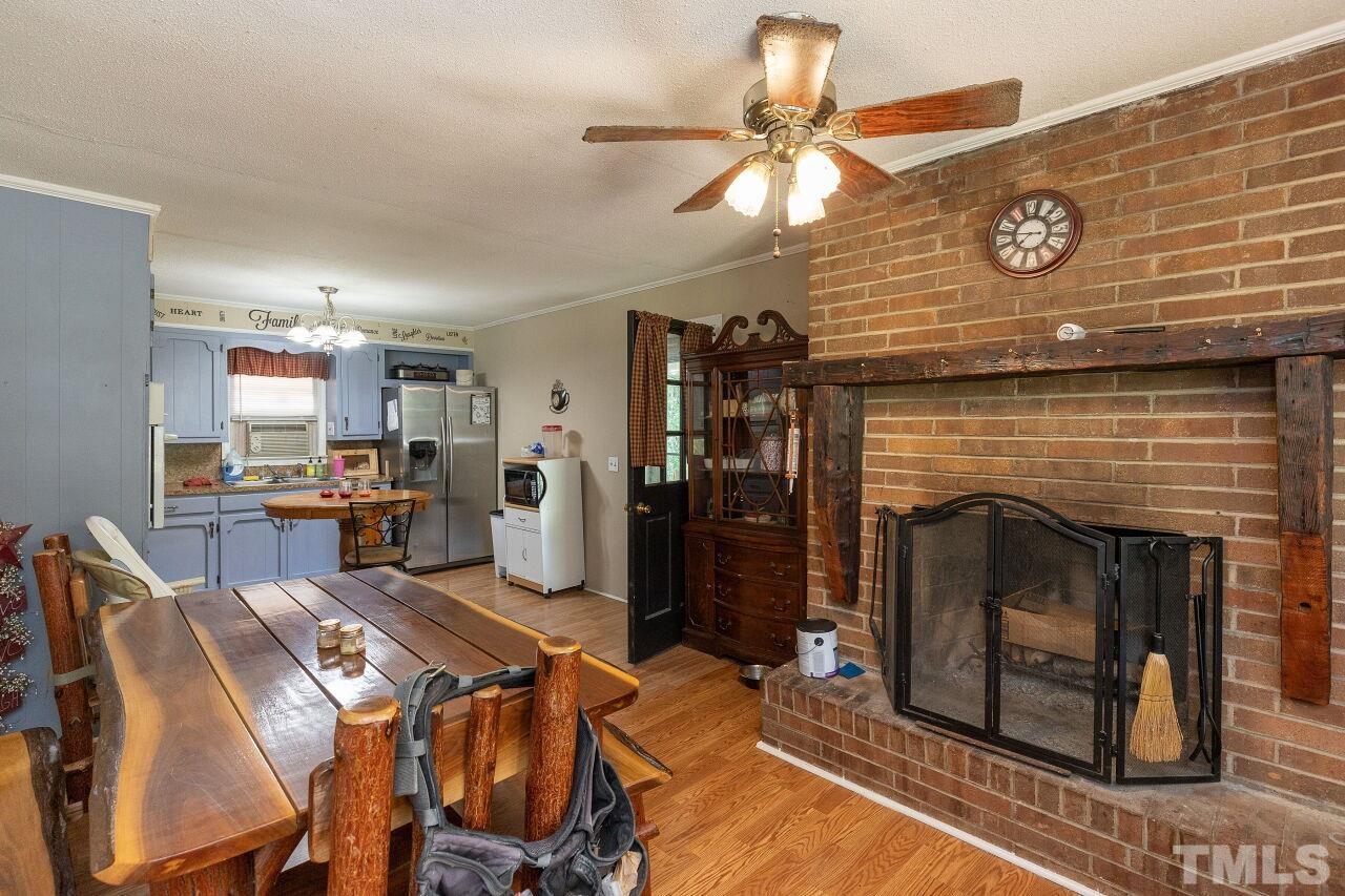 680 Haywood Bailey Road Roxboro, NC 27574 - Photo 8 of 29 a living room with furniture a fireplace and a flat screen tv