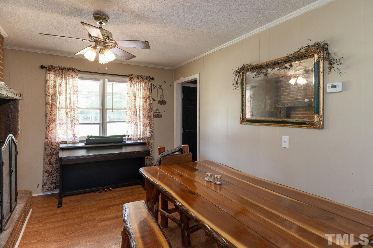 680 Haywood Bailey Road Roxboro, NC 27574 - Photo 9 of 29 a room with chandelier fan and windows