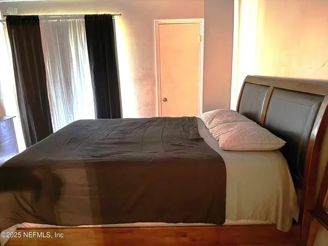 a bedroom with a bed and a mirror