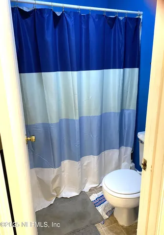 a bathroom with a toilet and shower