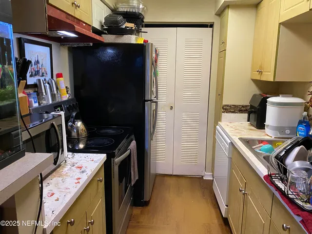 a kitchen with a stove and a refrigerator