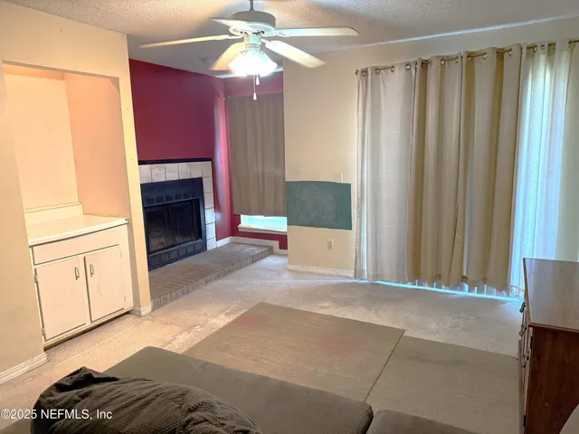 a view of livingroom with furniture and chandelier fan