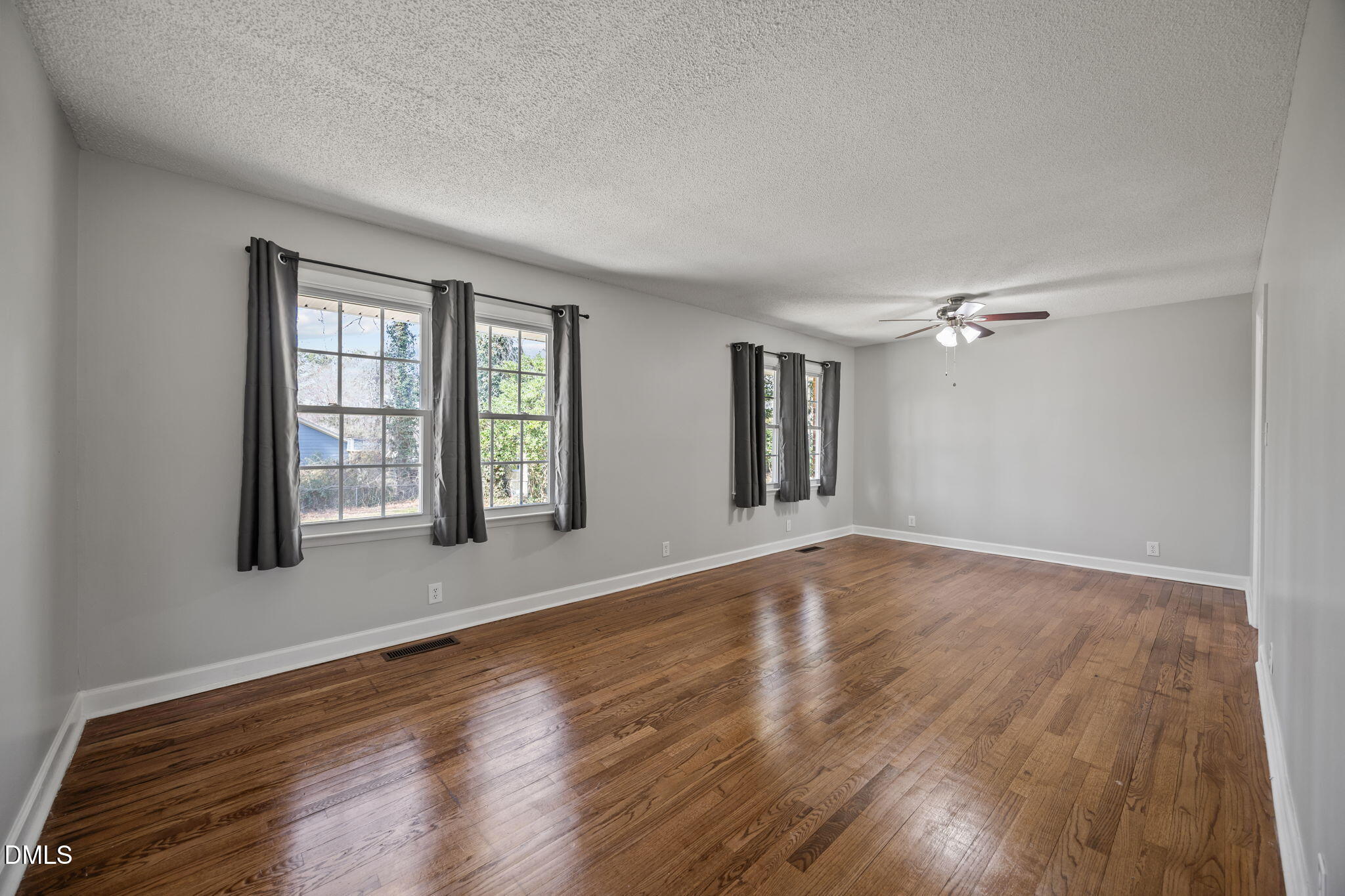 3521 Huntleigh Drive Raleigh, NC 27604 - Photo 13 of 56 a view of an empty room with wooden floor and a window