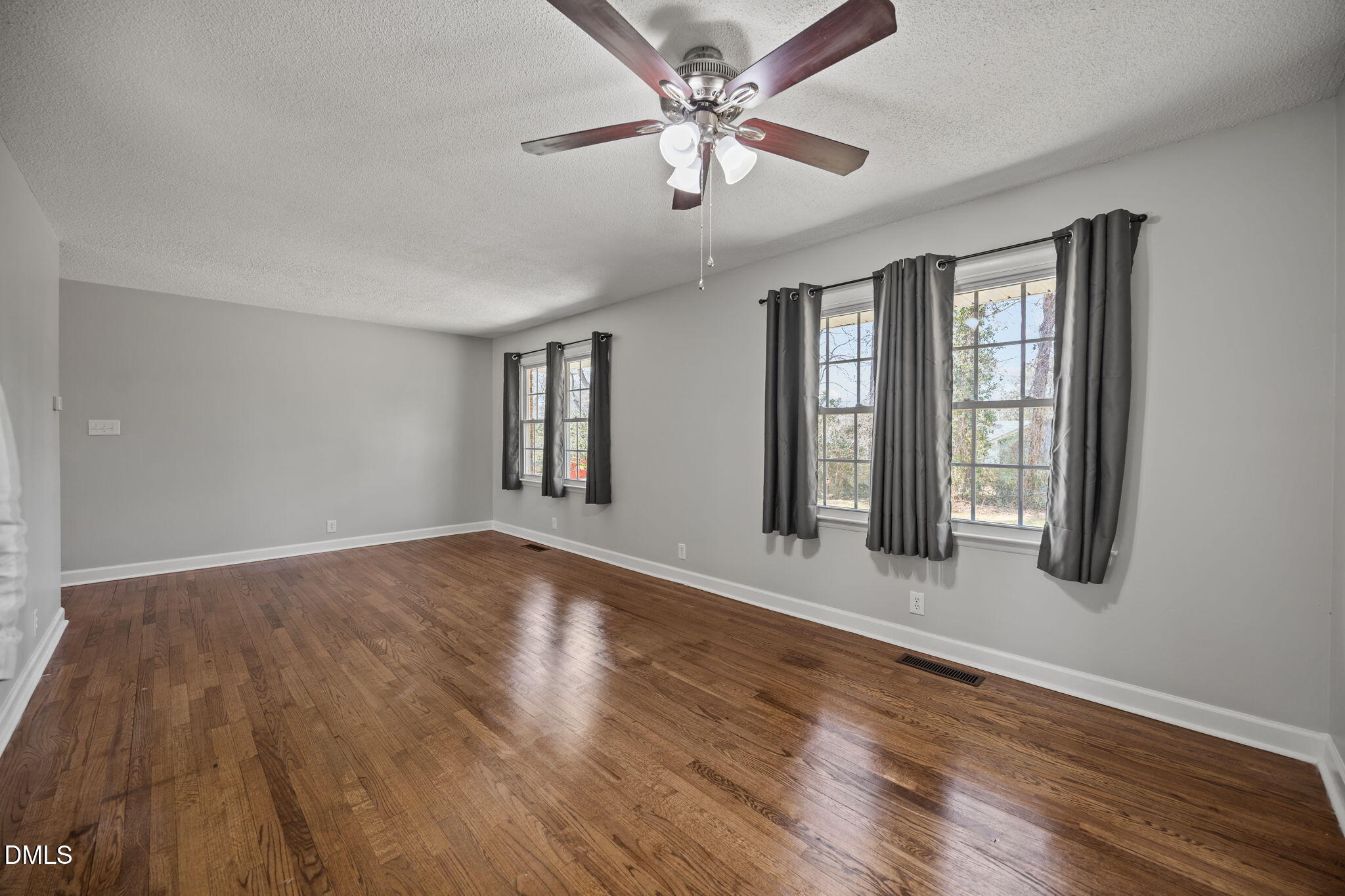 3521 Huntleigh Drive Raleigh, NC 27604 - Photo 14 of 56 a view of an empty room with window and wooden floor