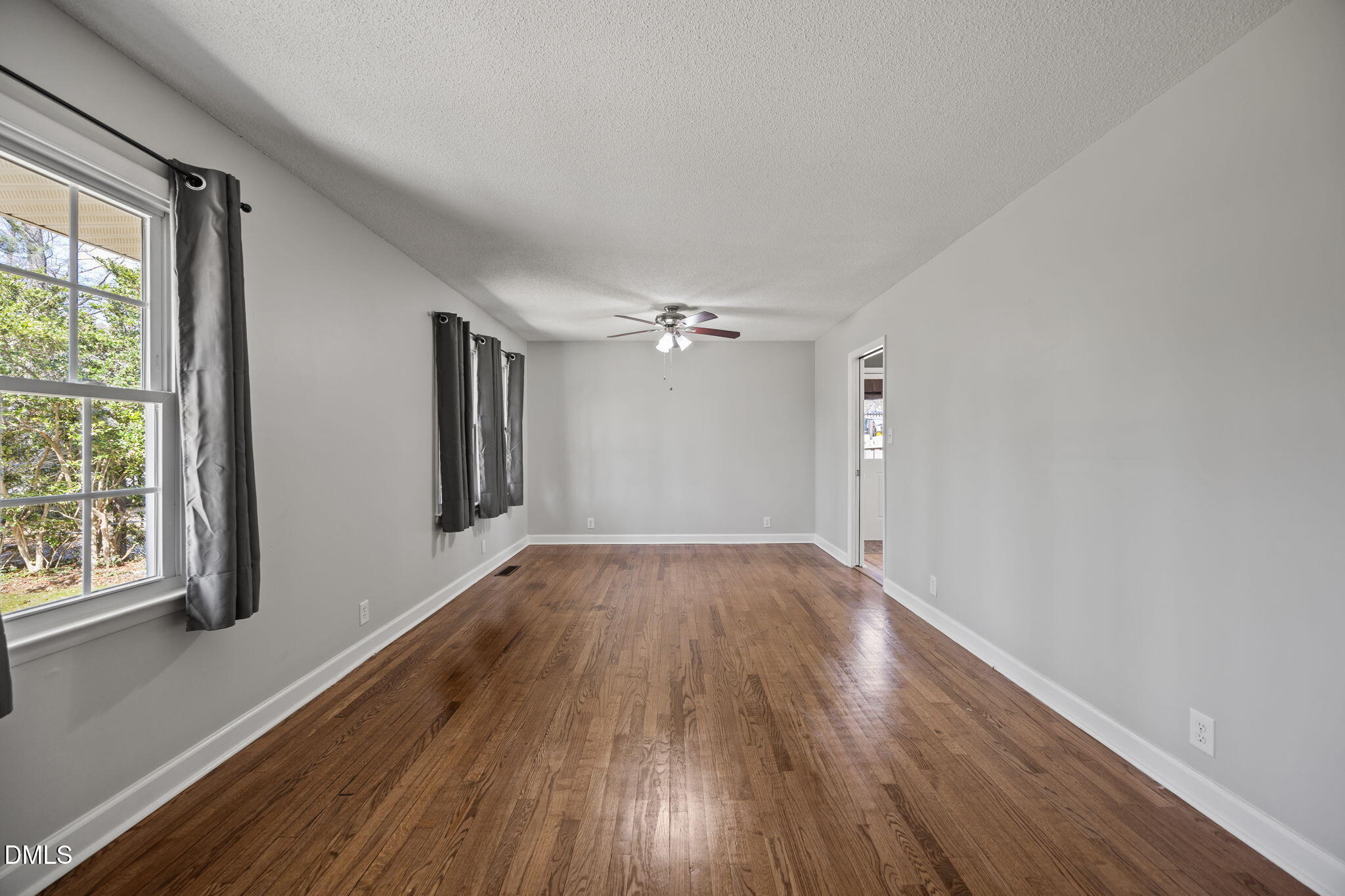 3521 Huntleigh Drive Raleigh, NC 27604 - Photo 15 of 56 a view of empty room with wooden floor and fan