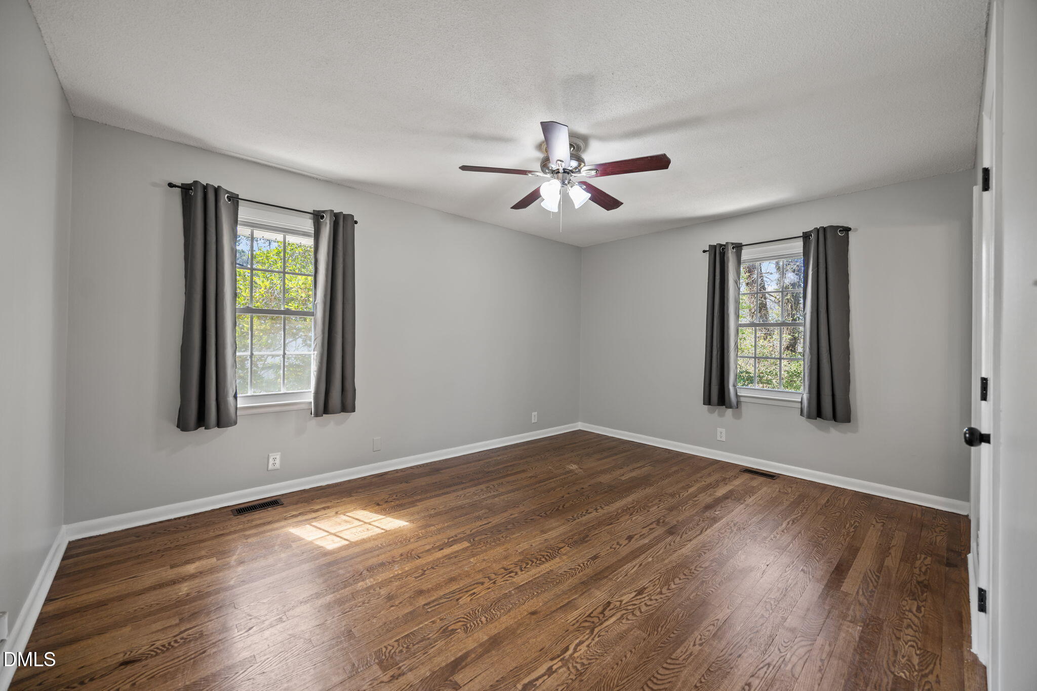 3521 Huntleigh Drive Raleigh, NC 27604 - Photo 17 of 56 a view of an empty room with window and wooden floor