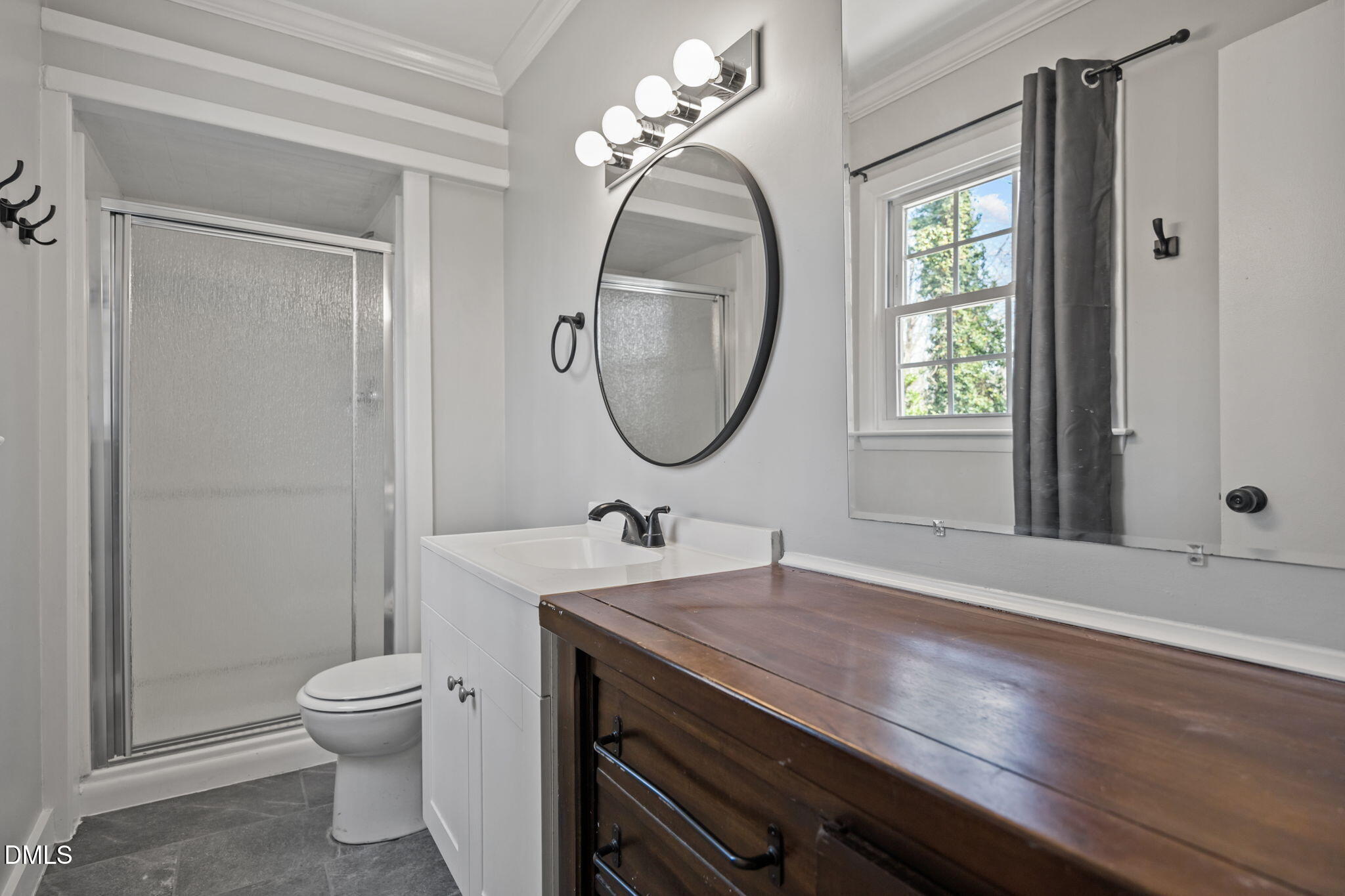 3521 Huntleigh Drive Raleigh, NC 27604 - Photo 19 of 56 a bathroom with a toilet a sink and a mirror