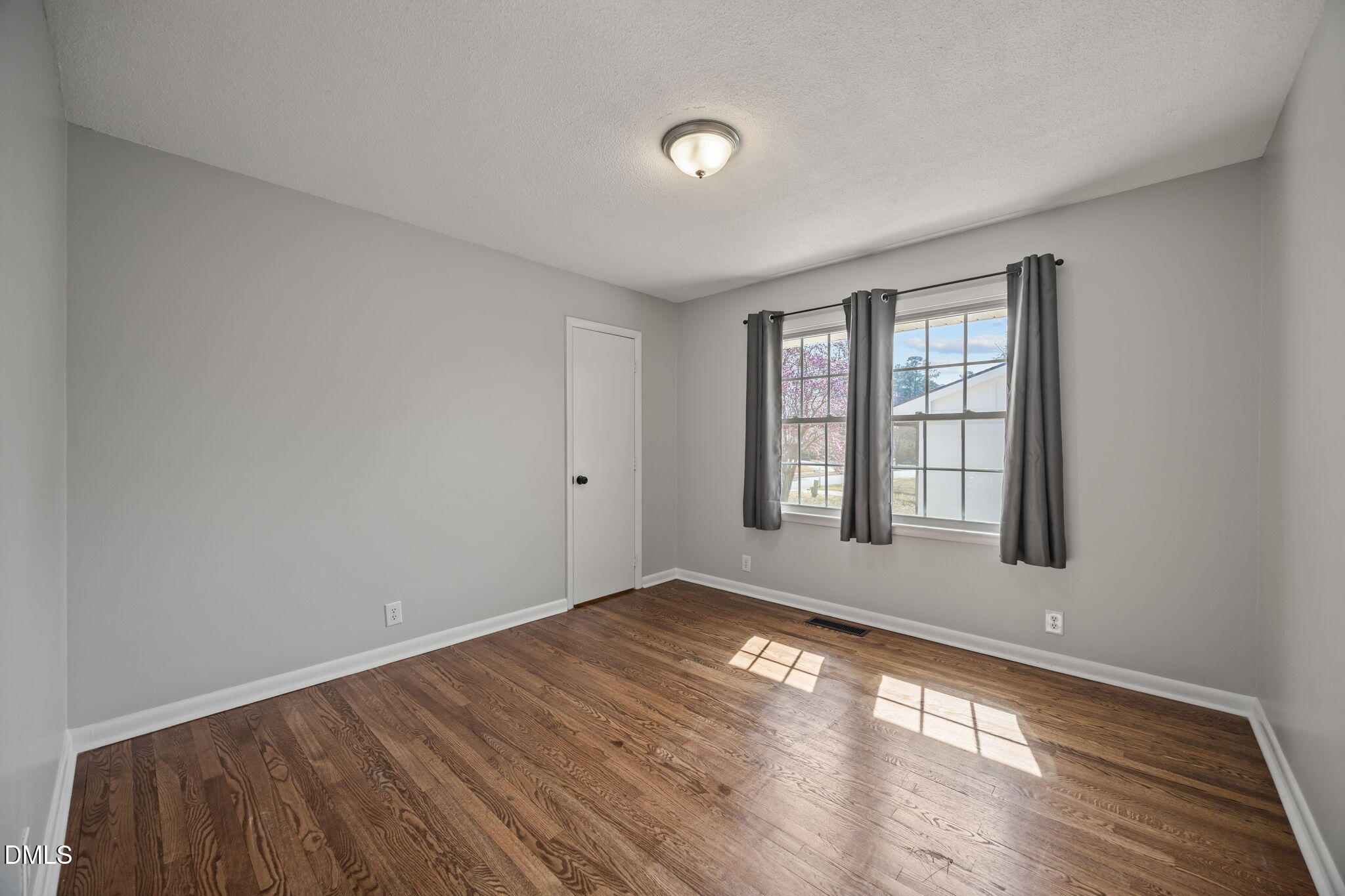 3521 Huntleigh Drive Raleigh, NC 27604 - Photo 24 of 56 an empty room with wooden floor and windows