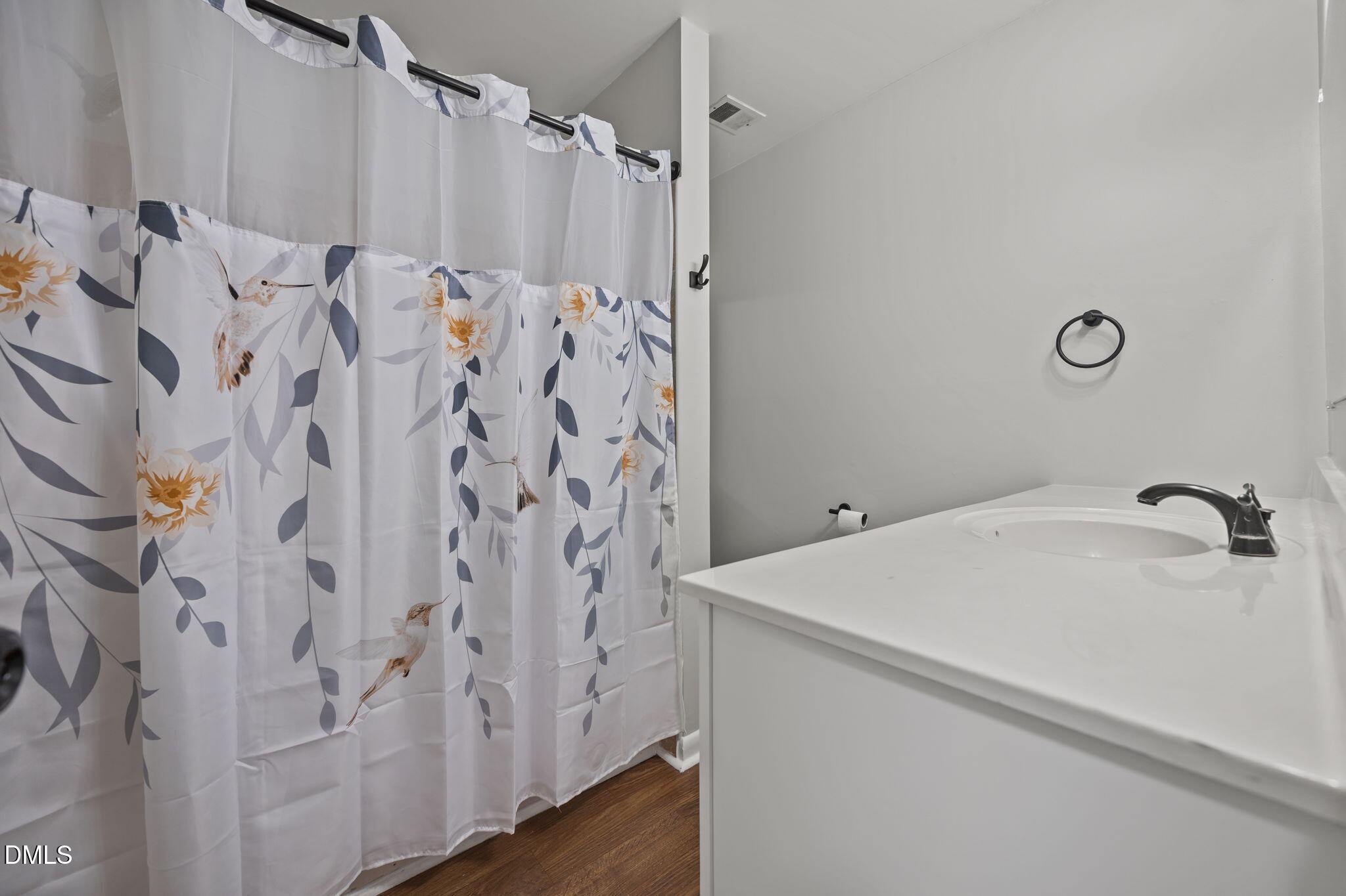 3521 Huntleigh Drive Raleigh, NC 27604 - Photo 25 of 56 a bathroom with a shower curtain and a sink