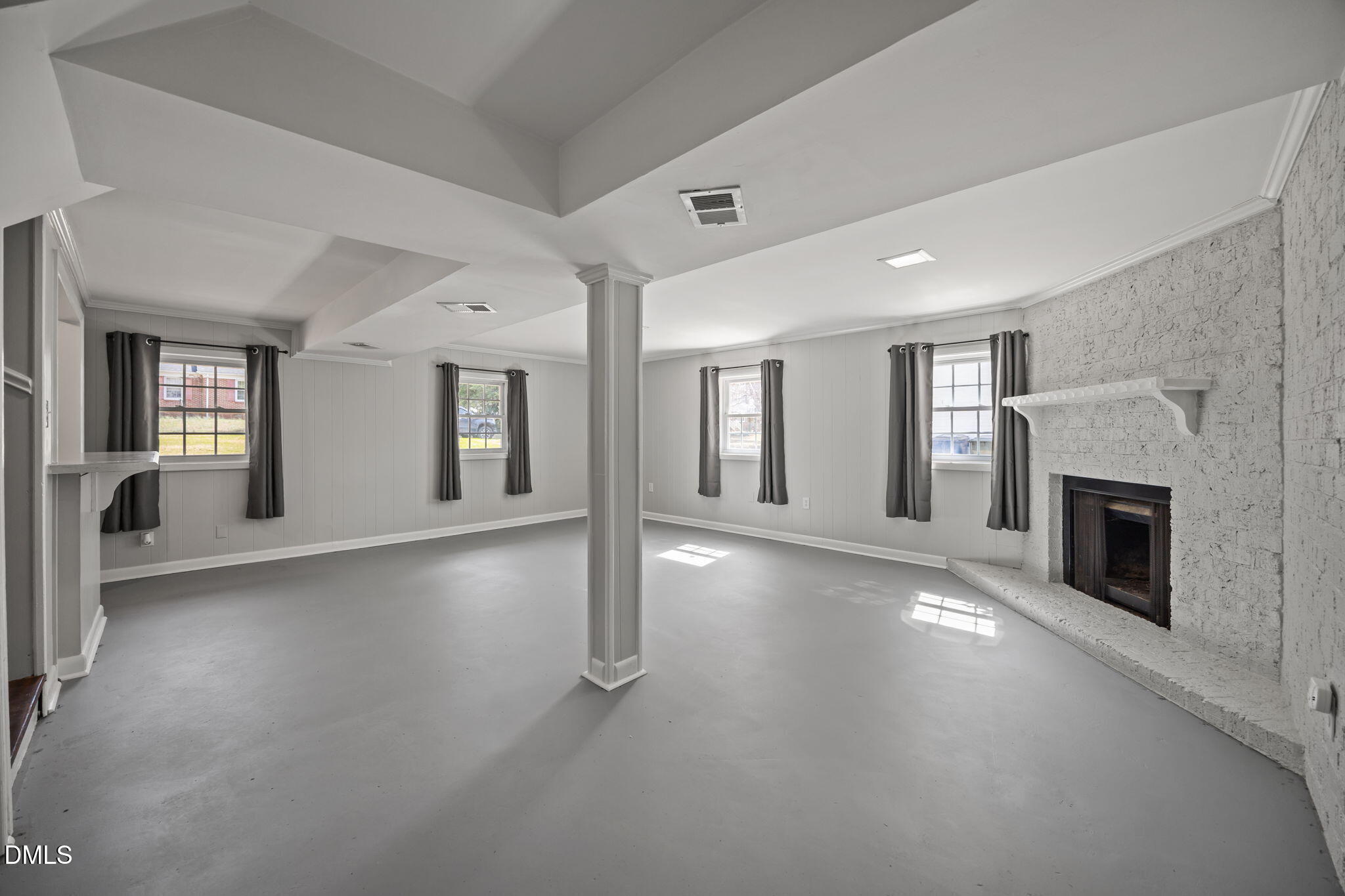 3521 Huntleigh Drive Raleigh, NC 27604 - Photo 30 of 56 an empty room with windows and fireplace