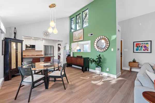 a view of a dining room with furniture and a chandelier