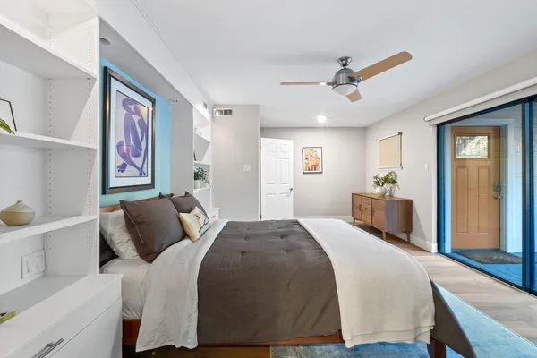 a bedroom with a large bed and a window