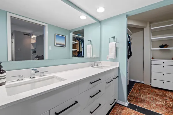 a bathroom with a sink double vanity and a mirror