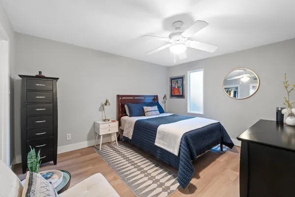 a bedroom with a bed and wooden floor