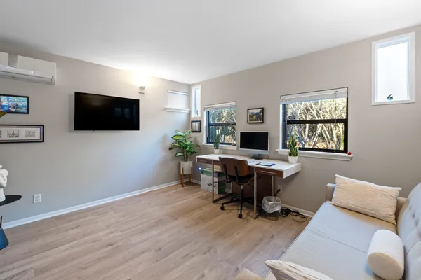 a view of a livingroom with workspace and a window