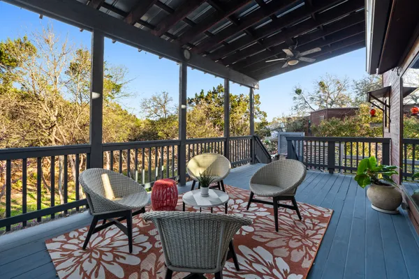 a view of a chair and tables in the balcony