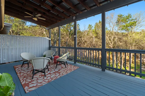 a roof deck with table and chairs and wooden floor
