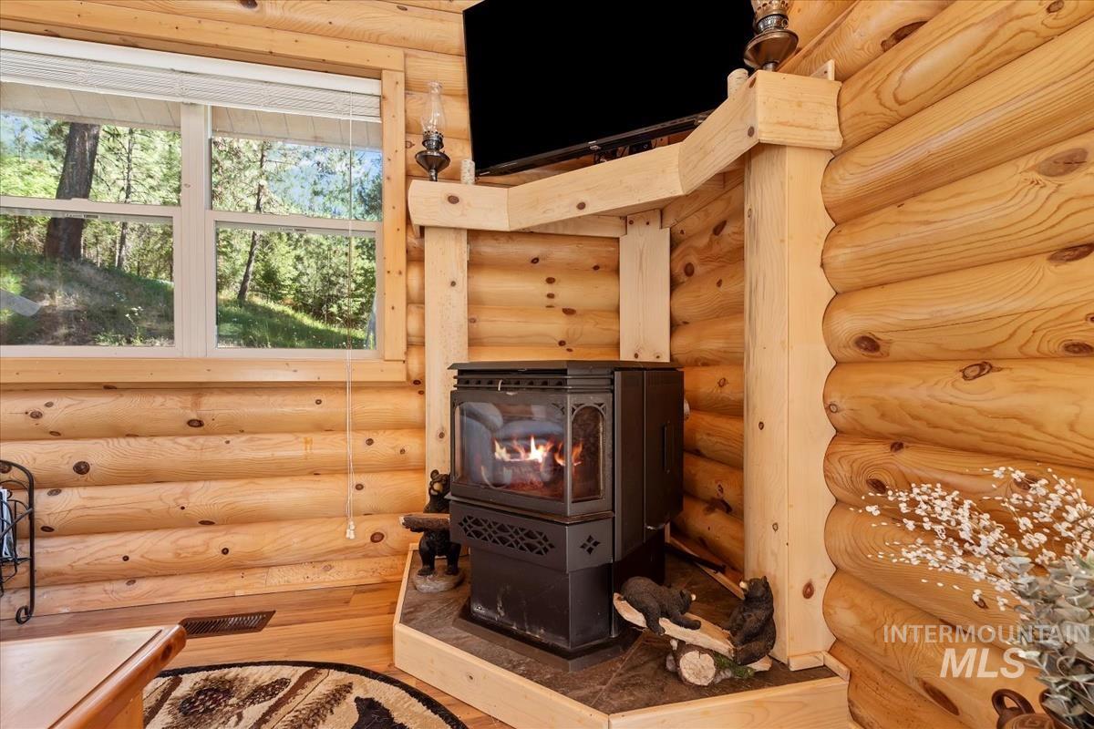10 Elk Point Road Garden Valley, ID 83622 - Photo 32 of 42 Detailed view of a wood stove and rustic walls