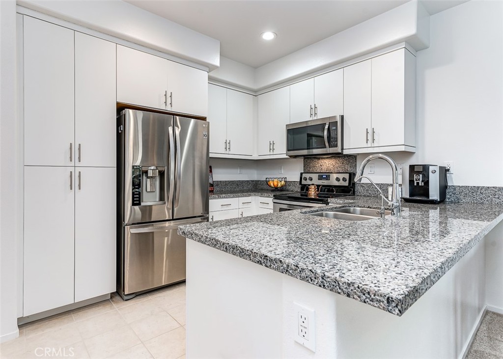 5756 Spring Street Buena Park, CA 90621 - Photo 2 of 16 a kitchen with granite countertop a refrigerator and a sink