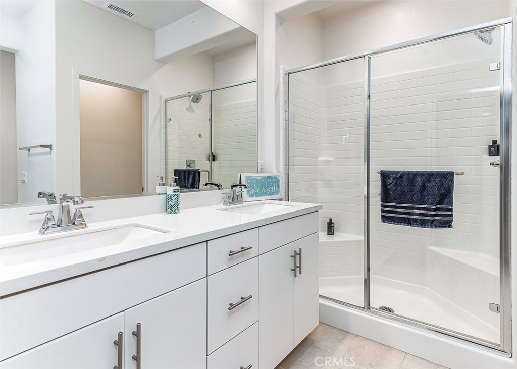 5756 Spring Street Buena Park, CA 90621 - Photo 6 of 16 a bathroom with a double vanity sink a mirror a glass door a shower and vanity