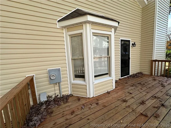 a view of a house with wooden fence