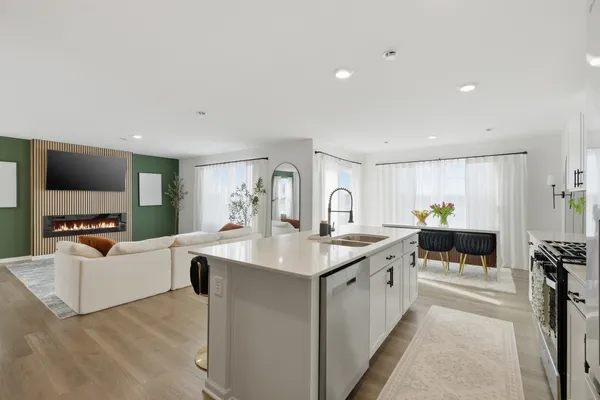 a kitchen with stainless steel appliances a stove microwave and sink