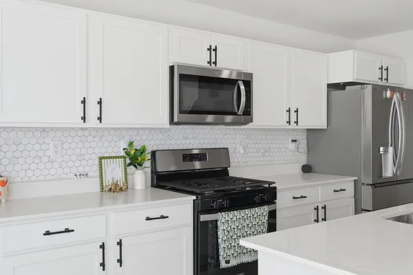 a kitchen with stainless steel appliances kitchen island granite countertop a sink and cabinets