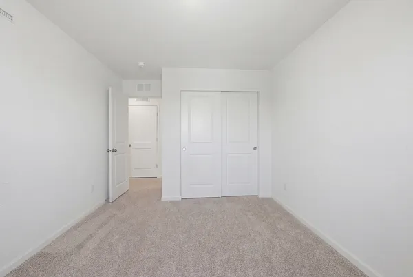 a bedroom with a bed and a table in it
