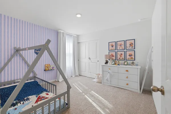 a bedroom with a bed and a table in it