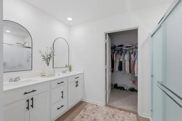 a bathroom with 2 sink tub and a mirror