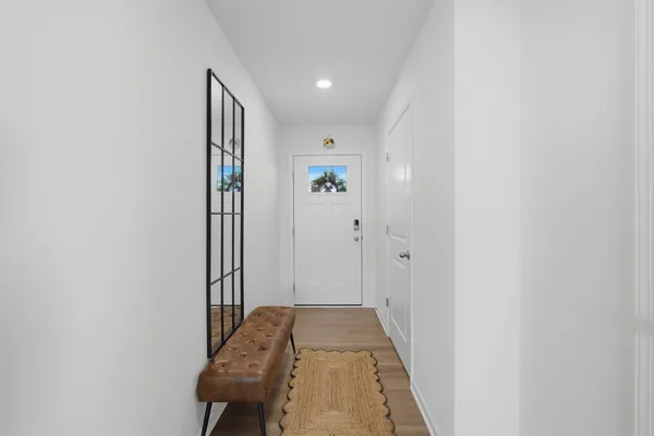 a view of a hallway with wooden shelves