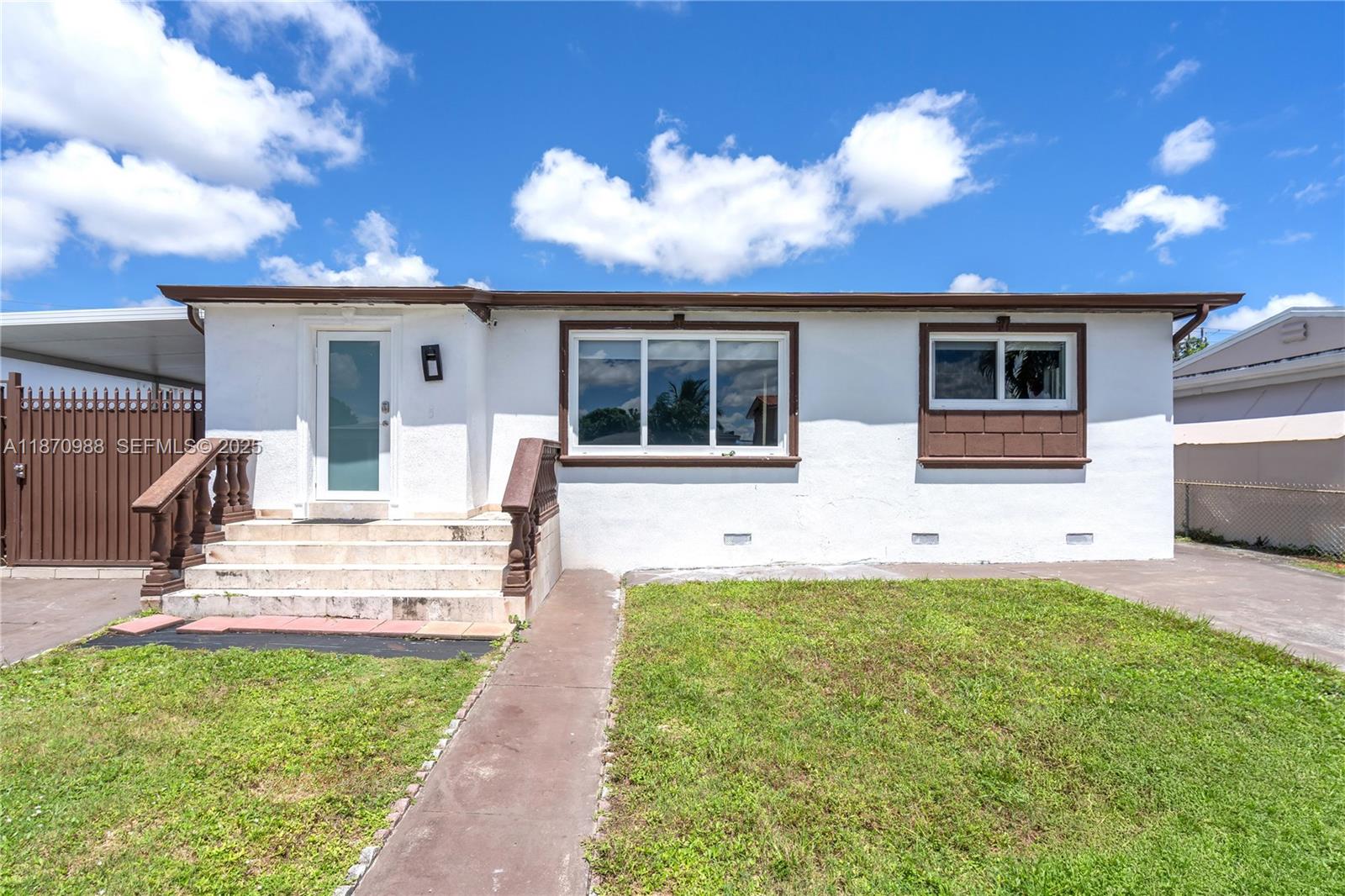 171 West 64th Street Hialeah, FL 33012 - Photo 2 of 22 front view of a house with a yard